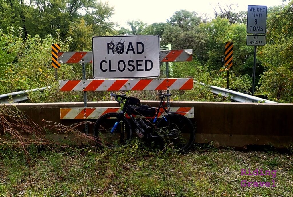 A bicycle against a Road Closed sign