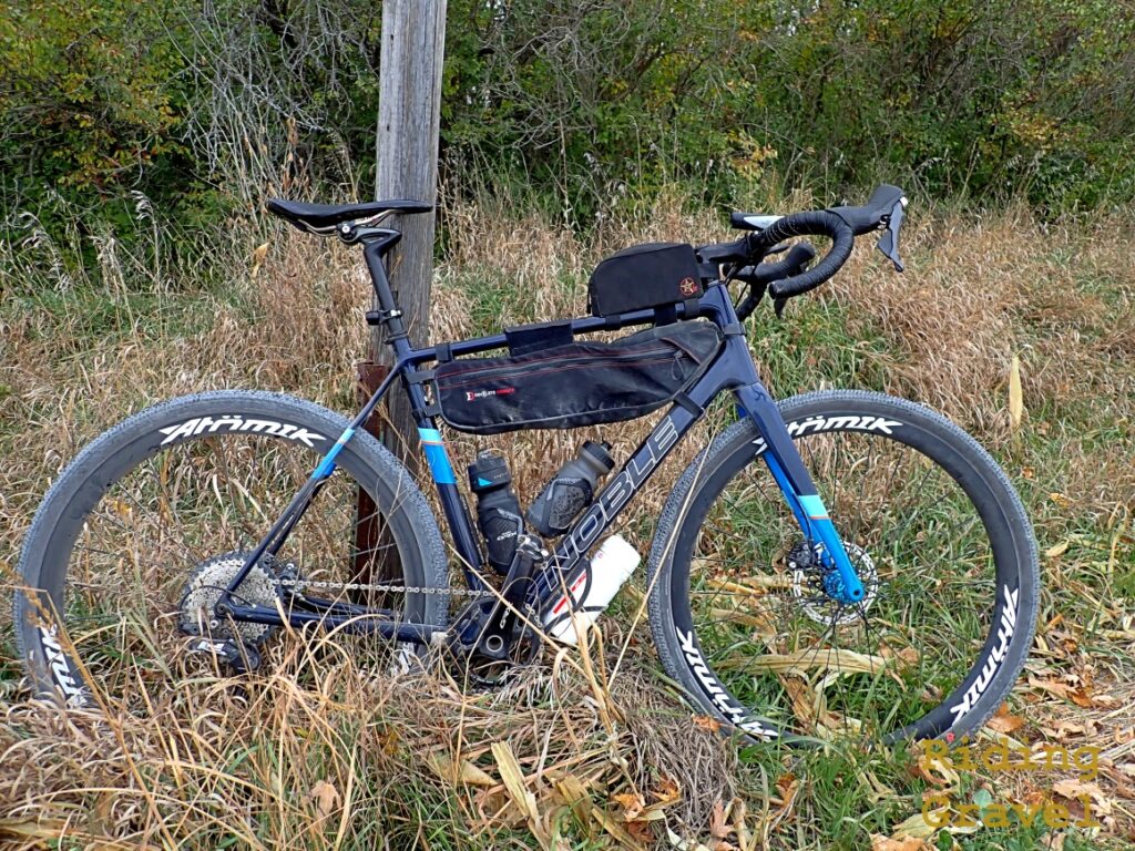 A bicycle leaning against a utility pole in a rural area