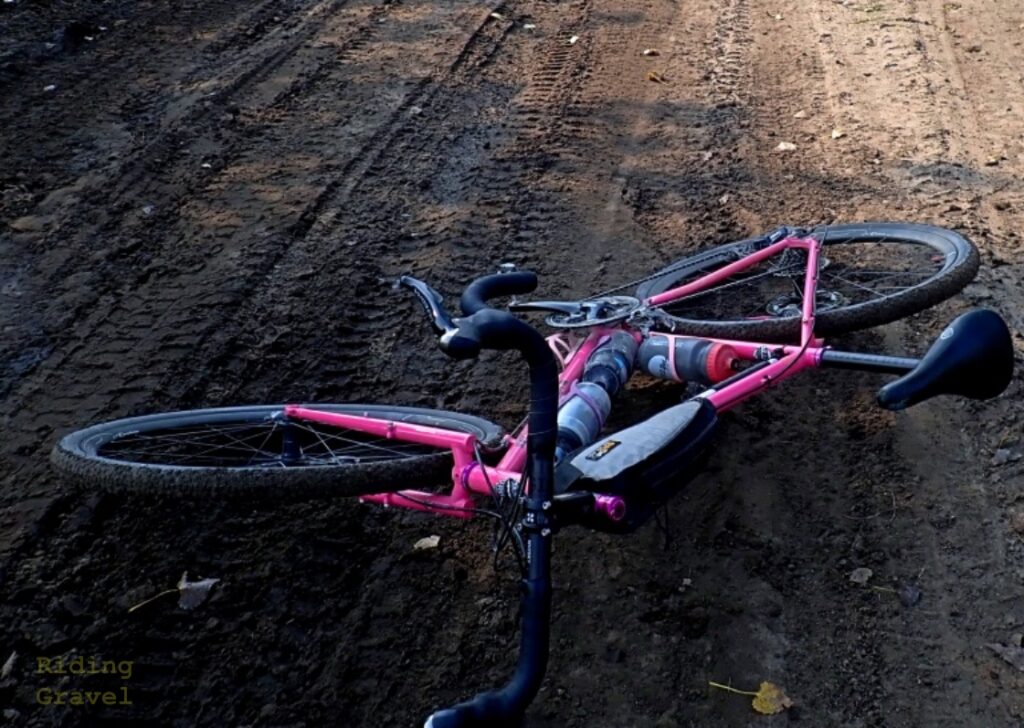 A pink bicycle on a dirt road