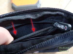 Red arrows point to zippered security pocket on the inside of the Muc-Off Rainproof Essentials Case