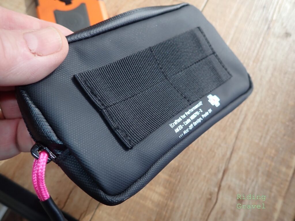 The back of the Muc-Off Rainproof Essentials Case features loops which can be used to attach the case to other bags. 