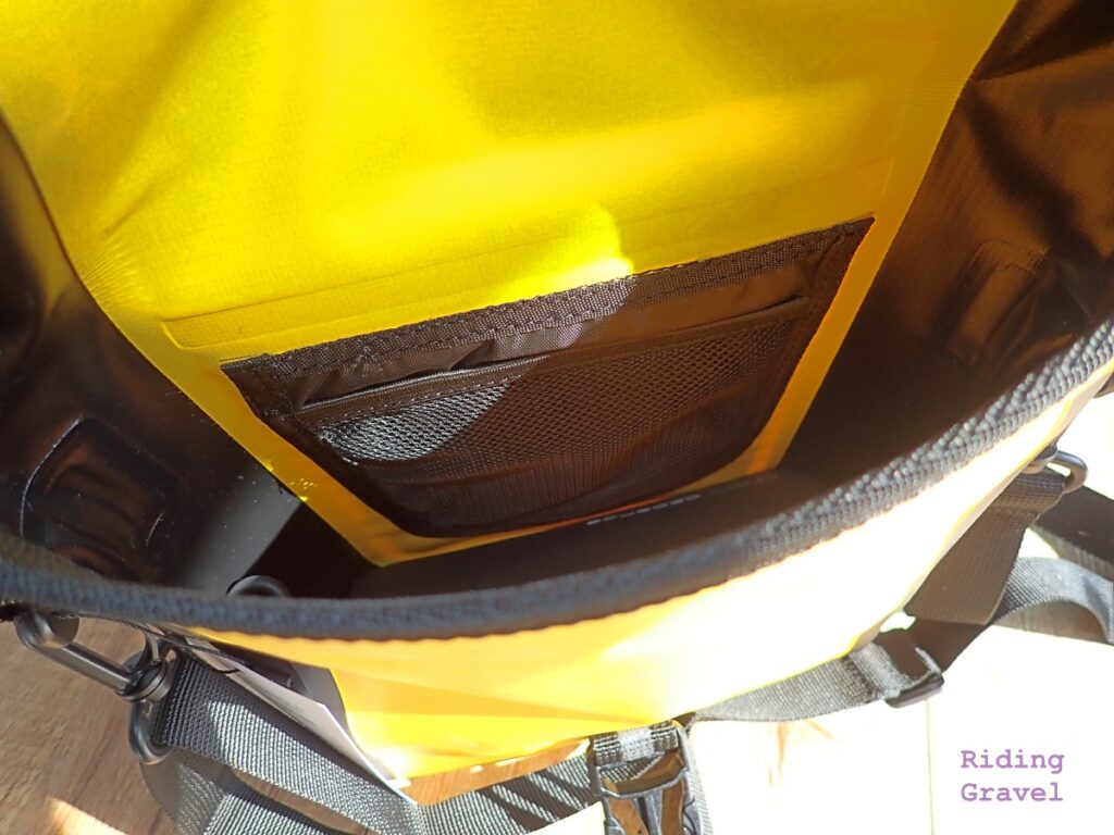 A close-up showing the interior of the Handle Bar Bag and the inner mesh pocket.
