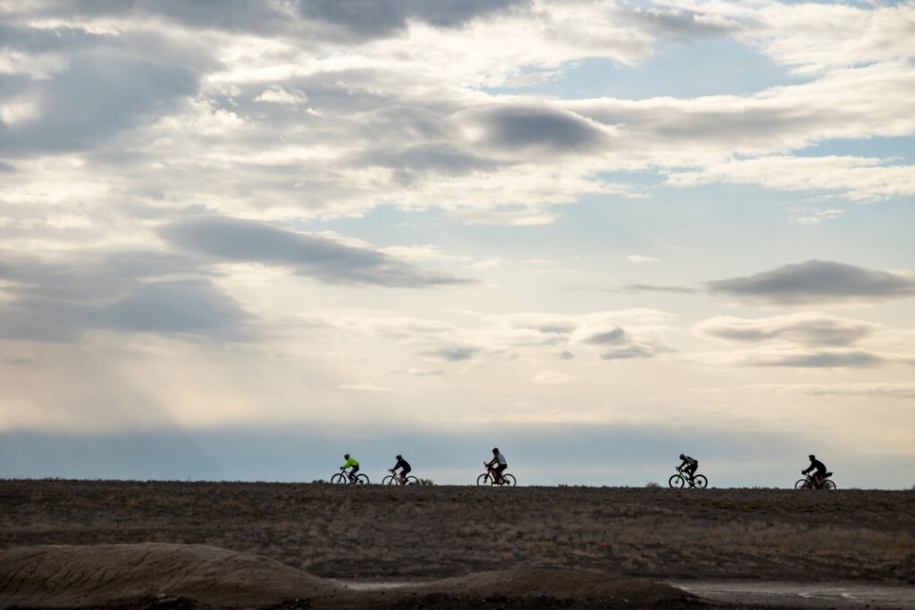 Riders in the Salty Lizard 100 seen silhouetted against the skyline. 
