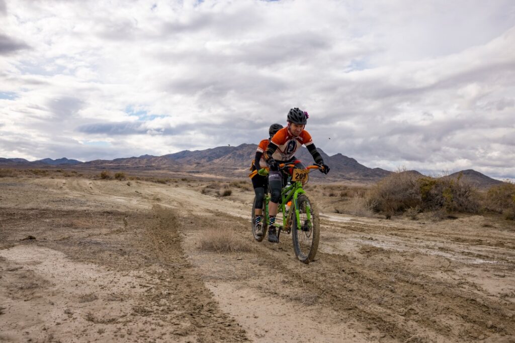 A tandem team grinds over some dirt on the Salty Lizard 100 course
