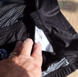 Detail on the Craft Cadence Recycled Performance Jersey showing the zippered security pocket. 