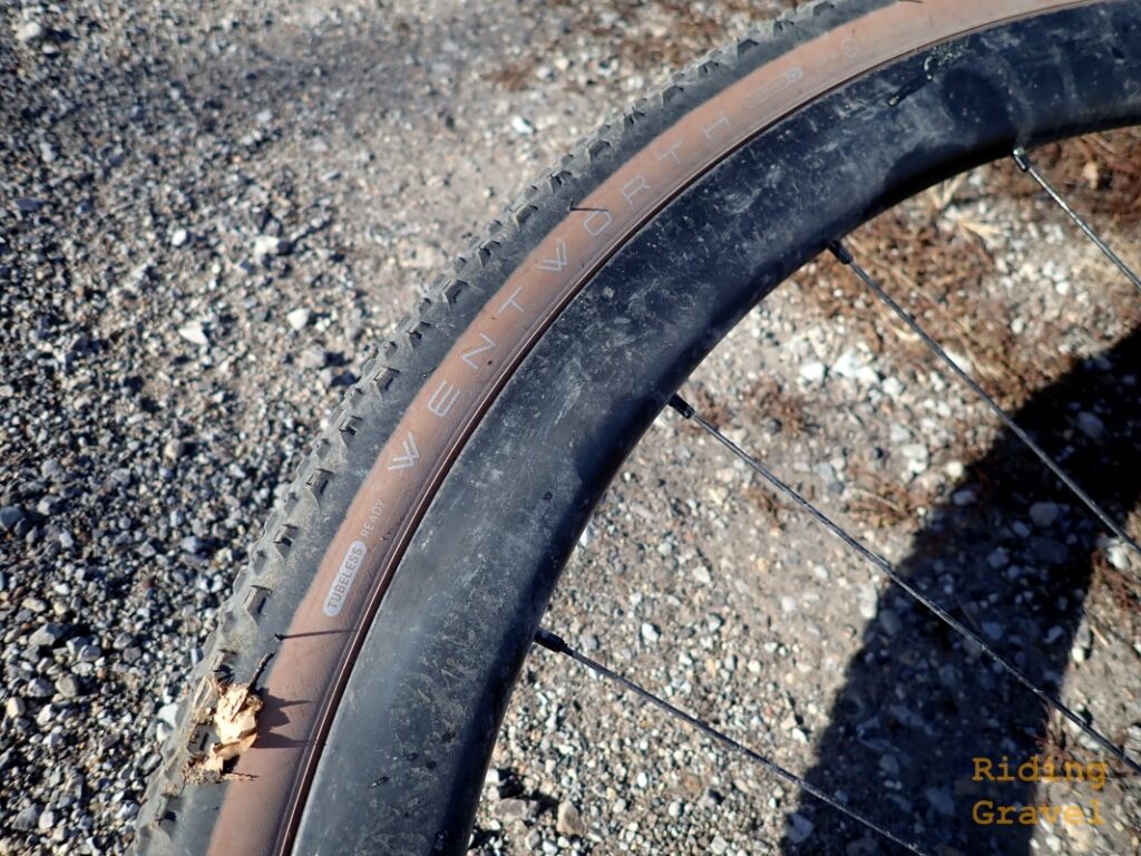 A close up of the American Classic 700c X 40mm Wentworth tire on a gravel road.