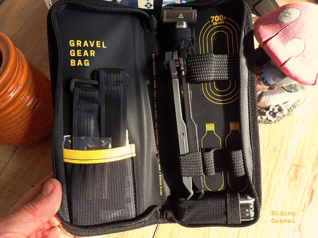 The Gravel Gear Bag opened up on a table top showing the tools inside.