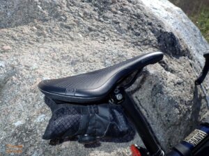 Close up of the Ergon SR Allroad Core Comp saddle on Guitar Ted's bike against a boulder.
