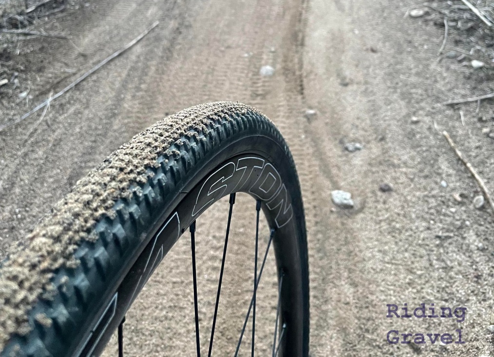 A close-up of a WTB Vulpine tire on a dirt road.