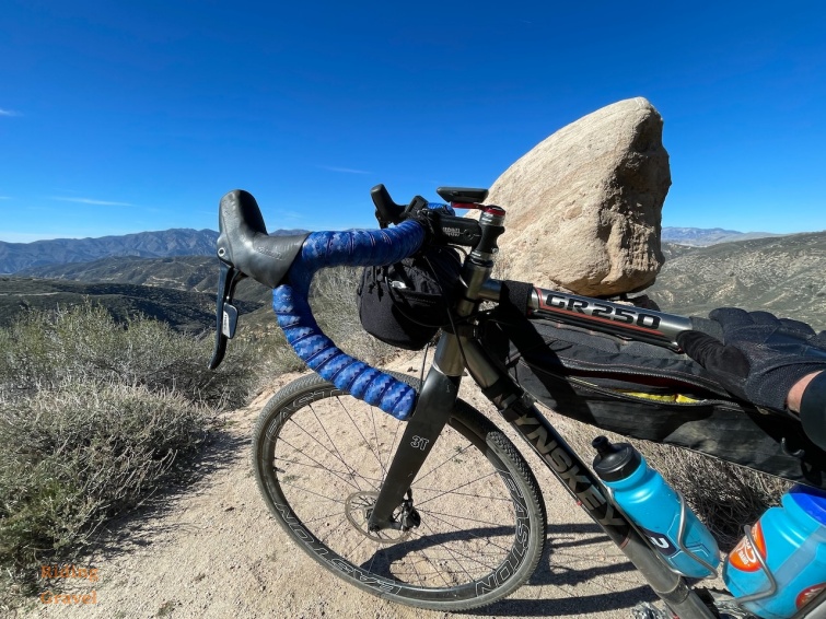 Grannygear's bike with the Astral Handle Bar Bag in a mountainous setting.