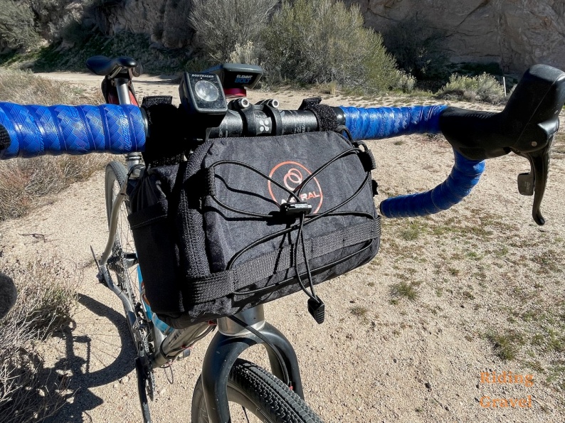 The Astral Handle Bar Bag on the front of a bicycle in a rural setting