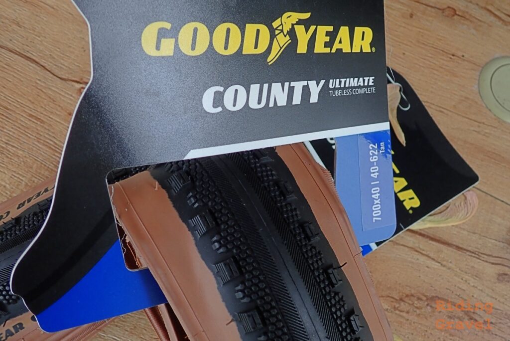 The Goodyear County tires in their retail packaging.
