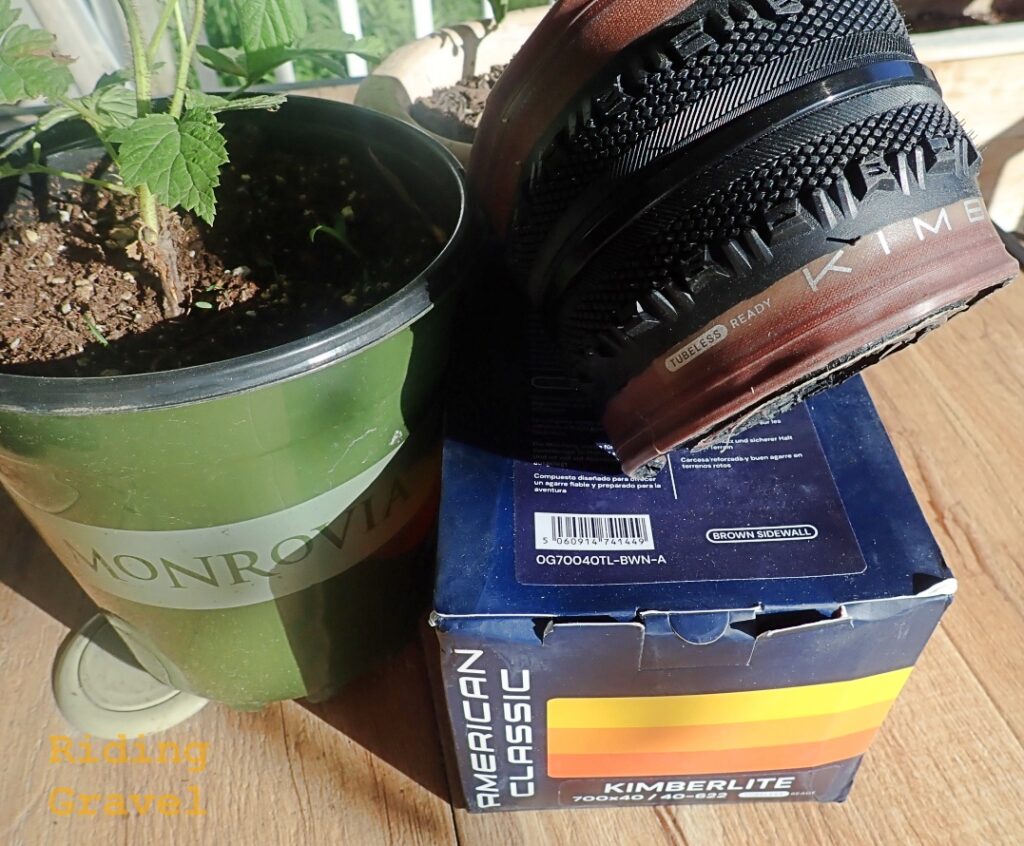 A rolled up Kimberlite tire on top of a box on a table with a plant. 