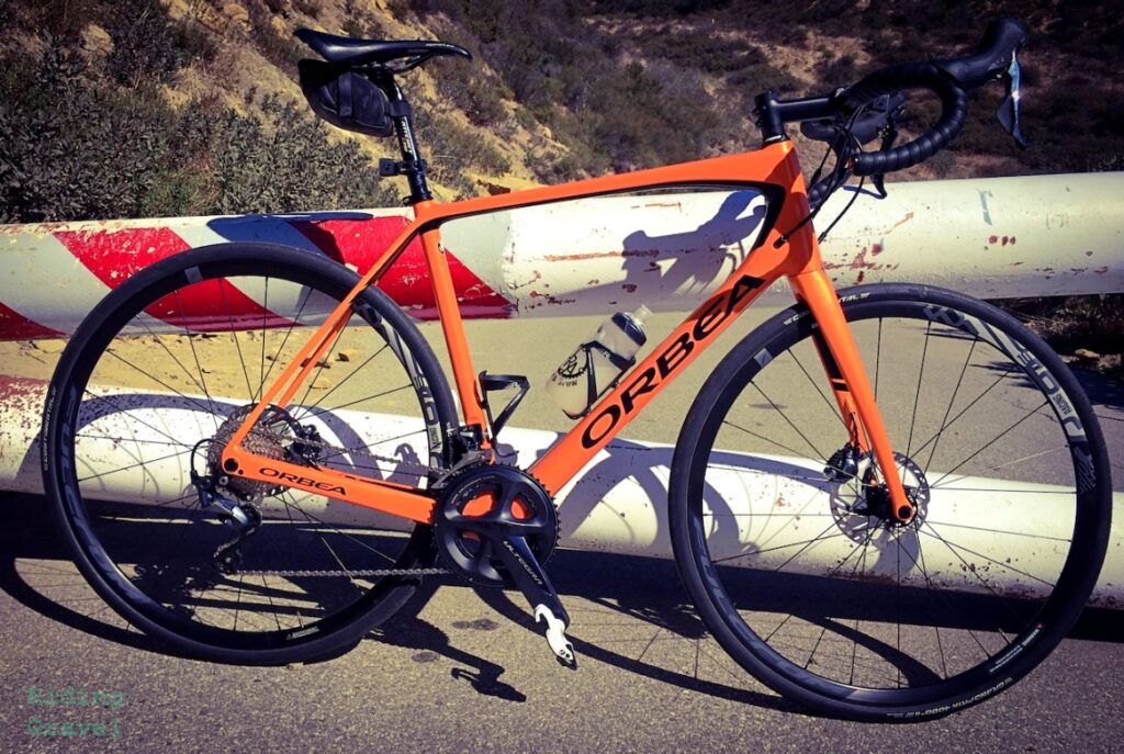 Orbea Avant Disc road bike against a barrier on a road. All Road