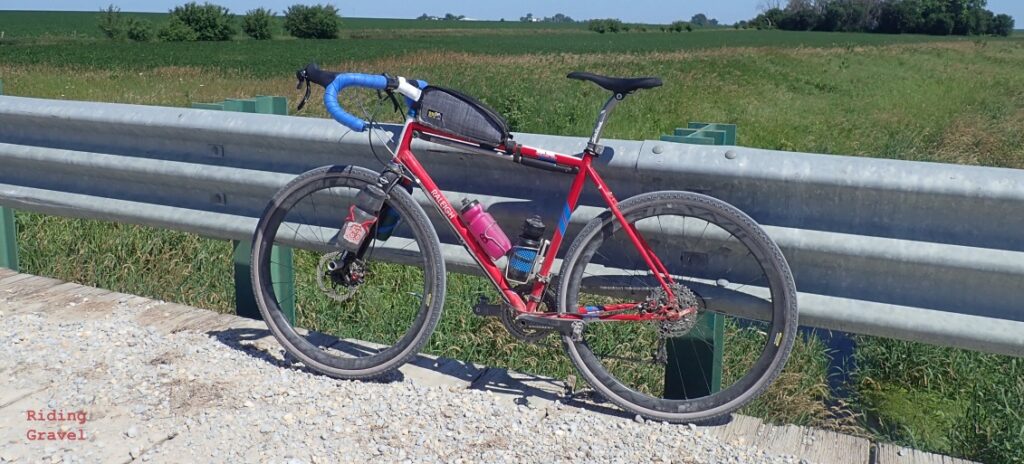 A bicycle with the Kimberlite tires leaning on an Armco barrier in a rural setting.
