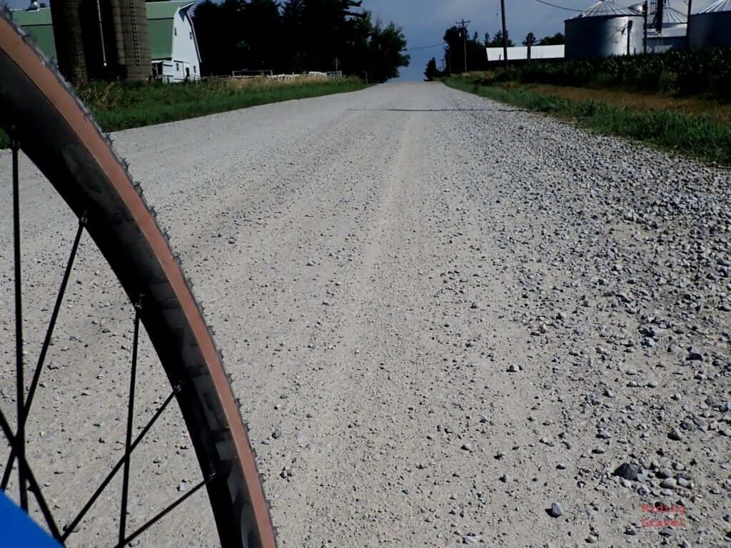 A close up of the County tire and a gravel road. 