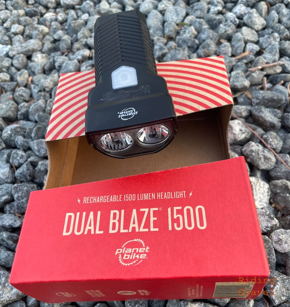 A close up of the Planet Bike Dual Blaze 1500 and its retail packaging.