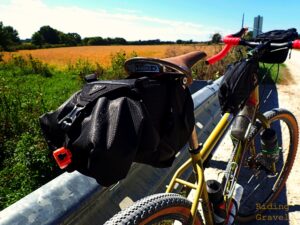 Topeak Backloader X seat pack on a bicycle in a rural setting. 