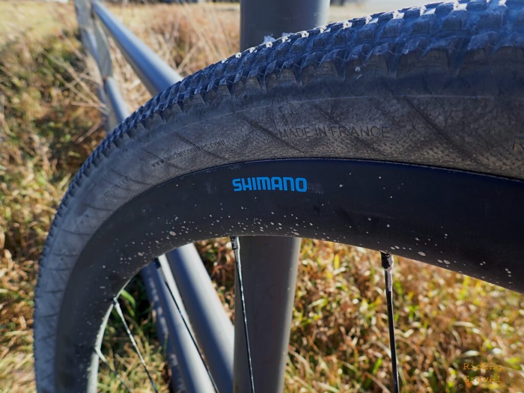 A close-up of the Shimano GRX Carbon wheel in a rural area.