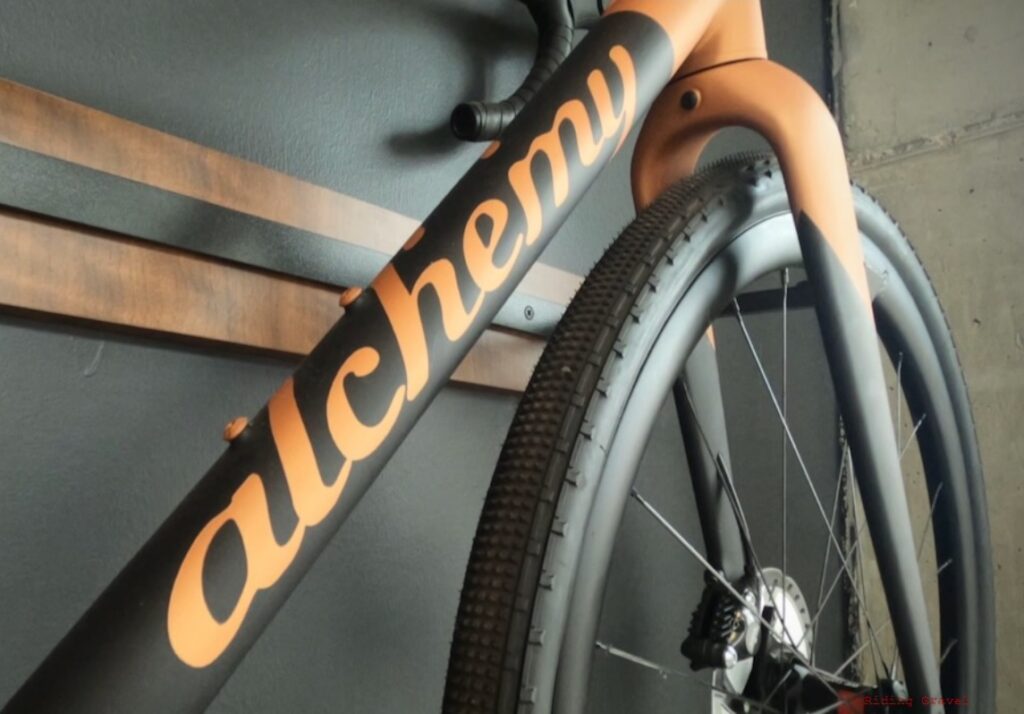 Detail of an Alchemy Bikes carbon frame with logo on downtube. 