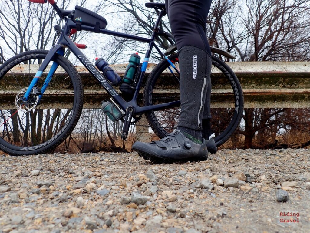 Low angle shot showing Guitar Ted wearing the Shimano RX801 shoes on a gravel road.