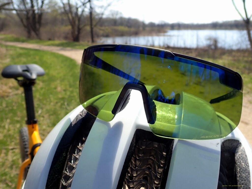 The S-Phyre Ridescape GR glasses on a helmet in a rural setting.