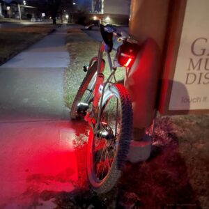 Nighttime image showing a bicycle with lights. 