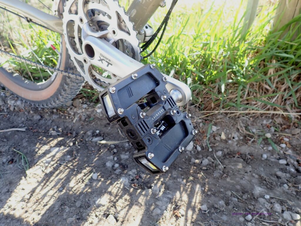 An image of an Arclight Pro pedal on a bike outdoors. 