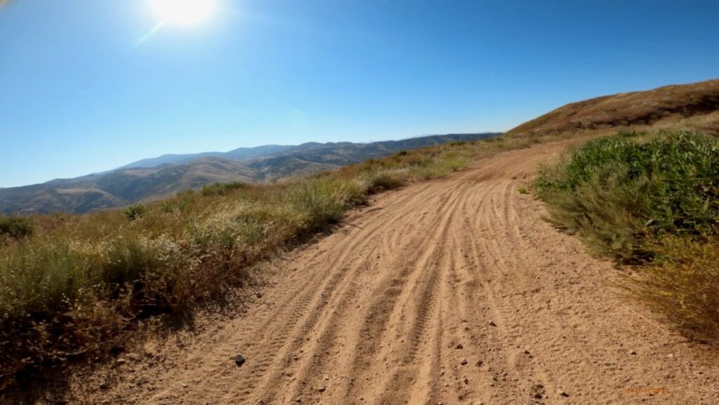 Image of dirt road in mountainous area. 
