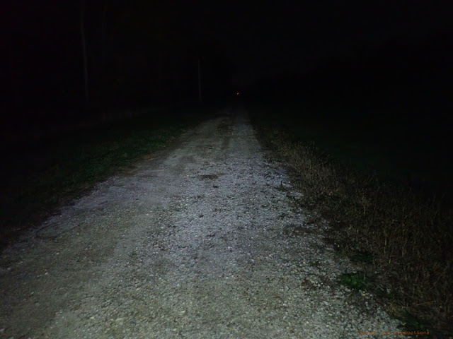 Night shot at Level 4 of the Volume light beam on a gravel path.