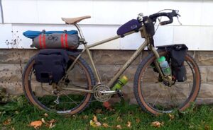 Side view of a loaded touring bike with the Ponderosa Pannier bags on the rear rack.